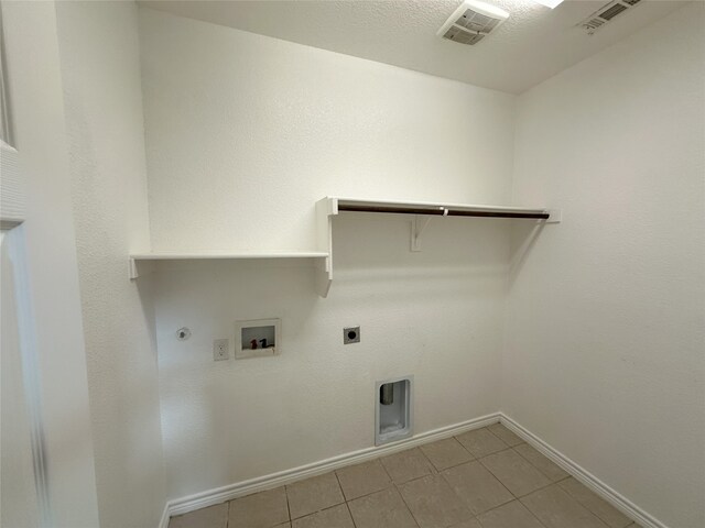 2408 Jill Creek Dr, Little Elm, TX 75068 - clothes washing area with washer hookup, electric dryer hookup, gas dryer hookup, baseboards, and light tile patterned flooring