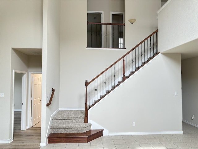 2408 Jill Creek Dr, Little Elm, TX 75068 - stairway featuring a towering ceiling and baseboards