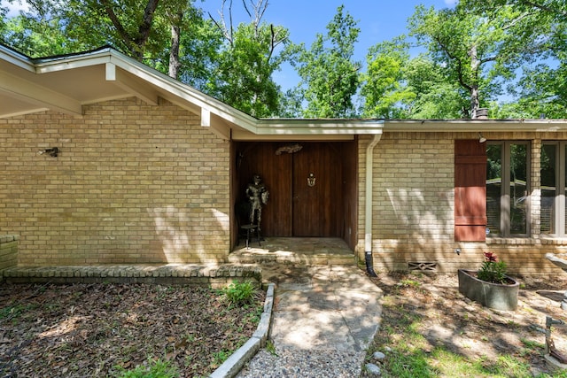 property entrance with brick siding