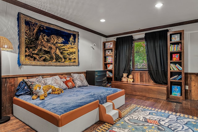 bedroom featuring wood-type flooring, wainscoting, ornamental molding, recessed lighting, and wooden walls