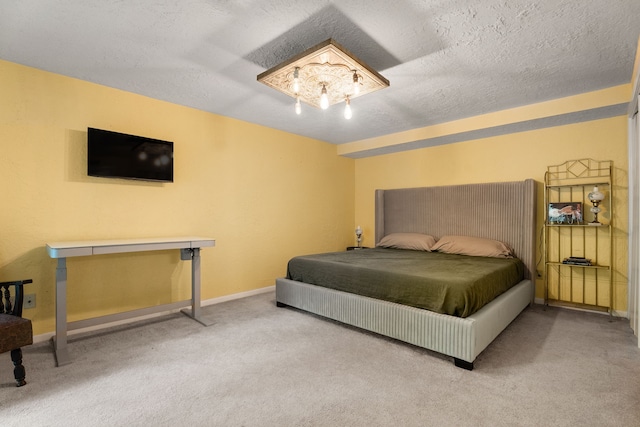 bedroom with carpet, baseboards, and a textured ceiling