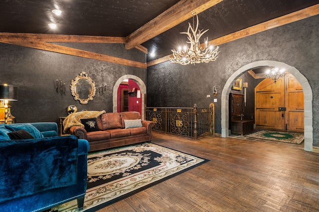 living area featuring arched walkways, wood finished floors, and a chandelier
