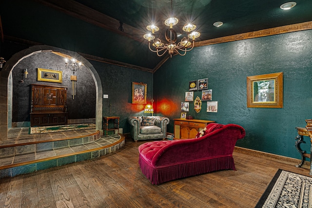 living area featuring arched walkways, wood finished floors, a chandelier, lofted ceiling, and a textured wall