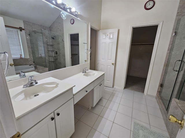 3406 Lake Highlands Dr, Rowlett, TX 75088 - bathroom featuring a shower stall, tile patterned floors, double vanity, a bath, and a spacious closet