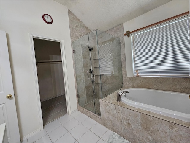 3406 Lake Highlands Dr, Rowlett, TX 75088 - bathroom featuring tile patterned floors, a shower stall, a garden tub, a spacious closet, and a textured ceiling