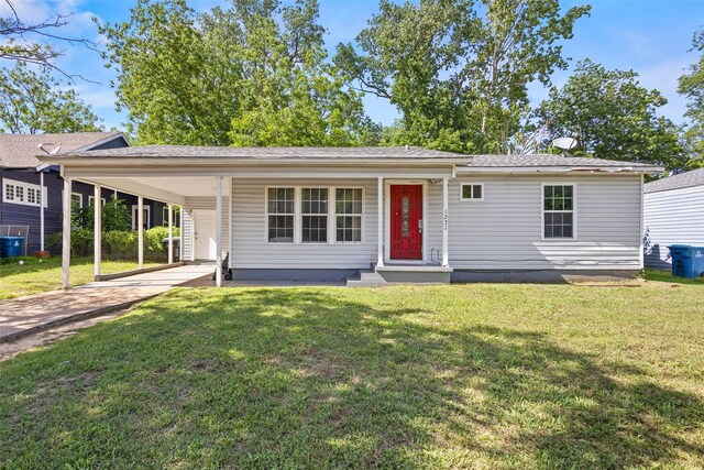 1221 W Crawford St, Denison, TX 75020 - ranch-style home featuring driveway, a front lawn, and a carport