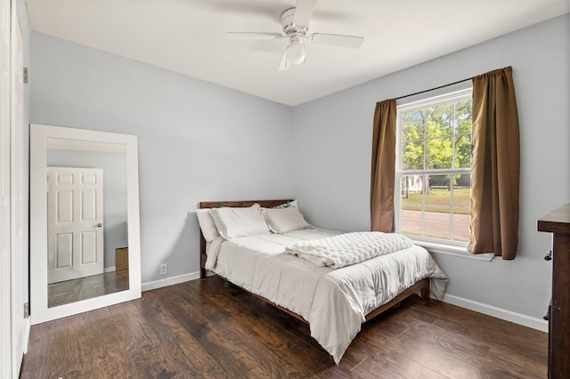 1221 W Crawford St, Denison, TX 75020 - bedroom with wood finished floors, baseboards, and a ceiling fan