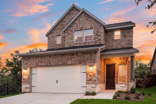 1301 Hickory Ct, Weatherford, TX 76086 - view of front facade with driveway, brick siding, an attached garage, and stone siding