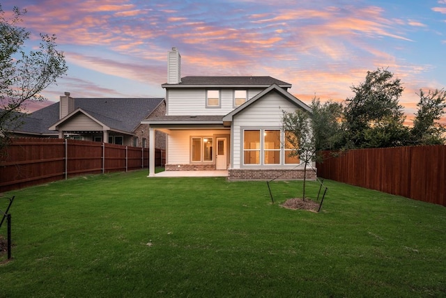1301 Hickory Ct, Weatherford, TX 76086 - back of property at dusk with a patio area and brick siding