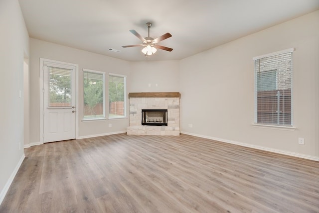 1301 Hickory Ct, Weatherford, TX 76086 - unfurnished living room featuring wood finished floors, a ceiling fan, a fireplace, and baseboards