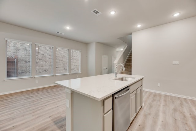 1301 Hickory Ct, Weatherford, TX 76086 - kitchen featuring dishwasher, a sink, light wood finished floors, a kitchen island with sink, and baseboards