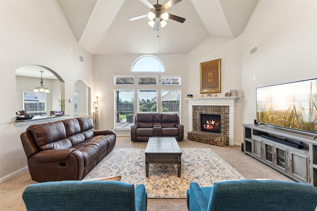 2314 Bob Sandlin Ln, Wylie, TX 75098 - living room featuring arched walkways, light colored carpet, ceiling fan, high vaulted ceiling, and a fireplace