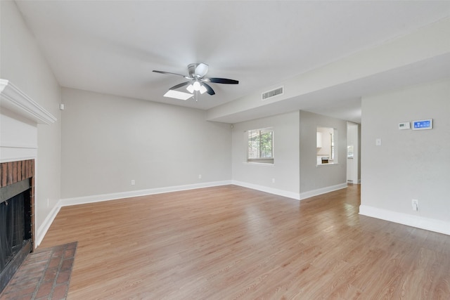 4914 Stagecoach Ln, Garland, TX 75043 - unfurnished living room featuring a fireplace, a ceiling fan, light wood finished floors, and baseboards