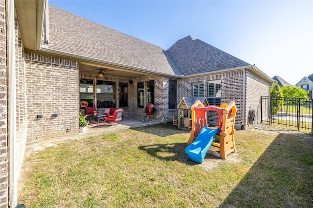 4207 Pearl Crescent Ln, Arlington, TX 76005 - back of property featuring roof with shingles, brick siding, a ceiling fan, and a patio area