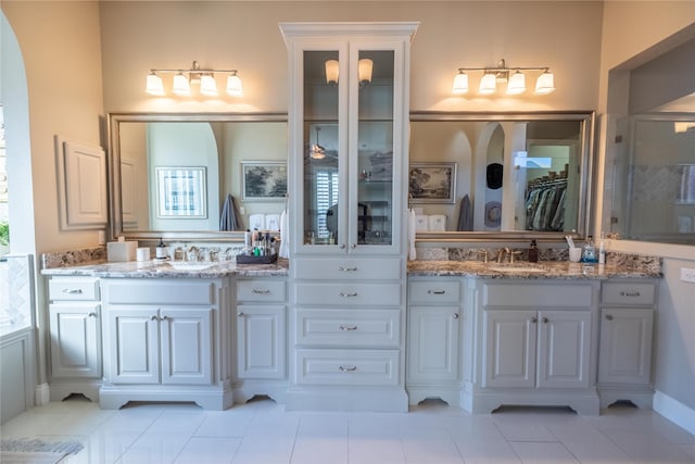 4207 Pearl Crescent Ln, Arlington, TX 76005 - bathroom featuring a shower stall, two vanities, tile patterned flooring, and a spacious closet