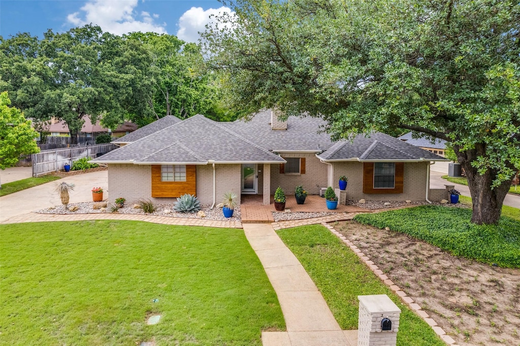 1039 Cypress Pt, Mansfield, TX 76063 - view of front of house with a shingled roof, brick siding, and a porch