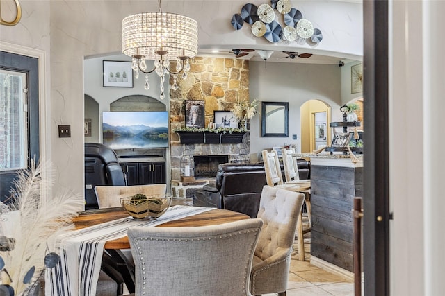 301 Shepherd Ln, Royse City, TX 75189 - dining space featuring a chandelier, tile patterned flooring, arched walkways, and a fireplace