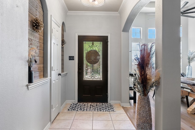 301 Shepherd Ln, Royse City, TX 75189 - entrance foyer featuring arched walkways, crown molding, baseboards, light tile patterned floors, and a ceiling fan