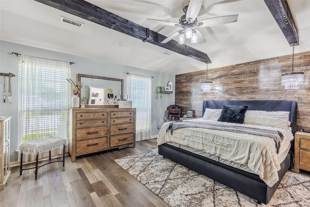 301 Shepherd Ln, Royse City, TX 75189 - bedroom featuring beamed ceiling, wooden walls, wood finished floors, and a ceiling fan