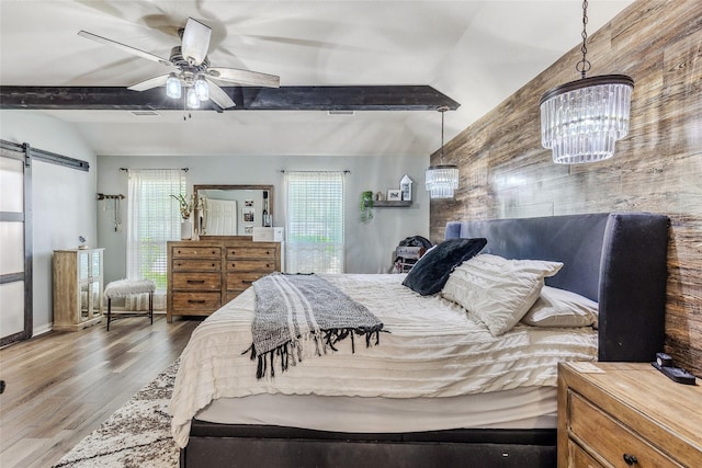 301 Shepherd Ln, Royse City, TX 75189 - bedroom with multiple windows, wood finished floors, a barn door, and a chandelier