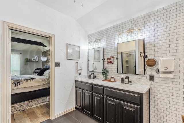 301 Shepherd Ln, Royse City, TX 75189 - ensuite bathroom featuring double vanity, vaulted ceiling, an enclosed shower, and decorative backsplash