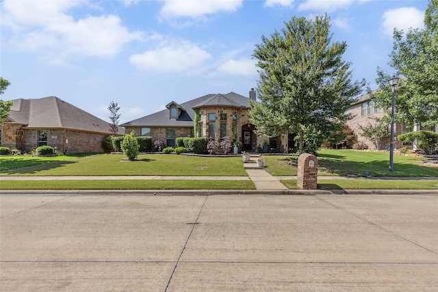 301 Shepherd Ln, Royse City, TX 75189 - view of front of house featuring a front lawn, brick siding, and a chimney