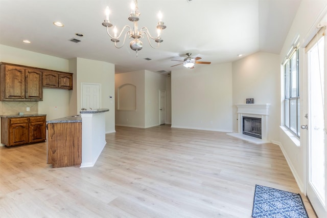 1716 Lake Way Dr, Little Elm, TX 75068 - kitchen with brown cabinetry, healthy amount of natural light, tasteful backsplash, light wood-style floors, and recessed lighting