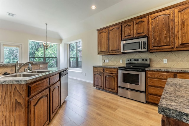 1716 Lake Way Dr, Little Elm, TX 75068 - kitchen featuring appliances with stainless steel finishes, a sink, tasteful backsplash, vaulted ceiling, and dark countertops