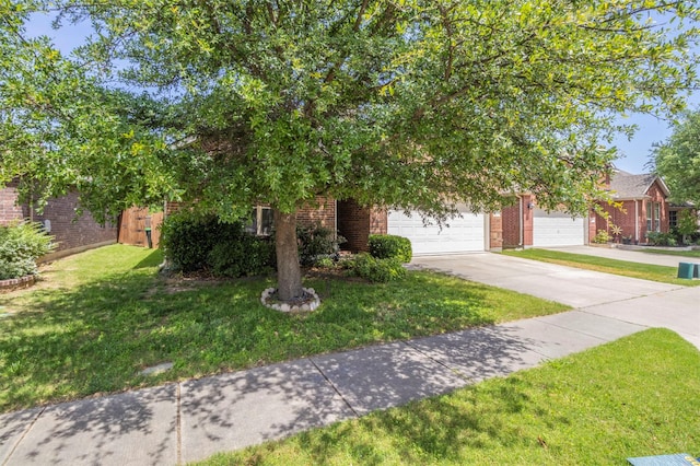 1716 Lake Way Dr, Little Elm, TX 75068 - obstructed view of property featuring brick siding, a front yard, driveway, and a garage