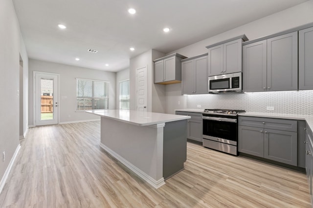 3510 Riley St, Fate, TX 75087 - kitchen featuring gray cabinetry, stainless steel appliances, light wood finished floors, and recessed lighting