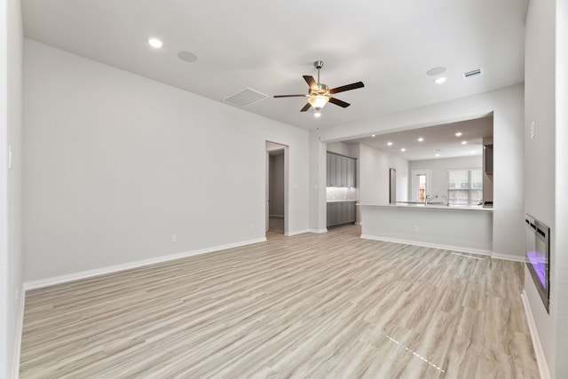 3510 Riley St, Fate, TX 75087 - unfurnished living room with ceiling fan, light wood-style flooring, recessed lighting, and baseboards