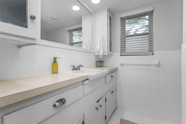 5845 E University Blvd Unit A, Dallas, TX 75206 - bathroom with vanity, healthy amount of natural light, tile walls, recessed lighting, and a wainscoted wall