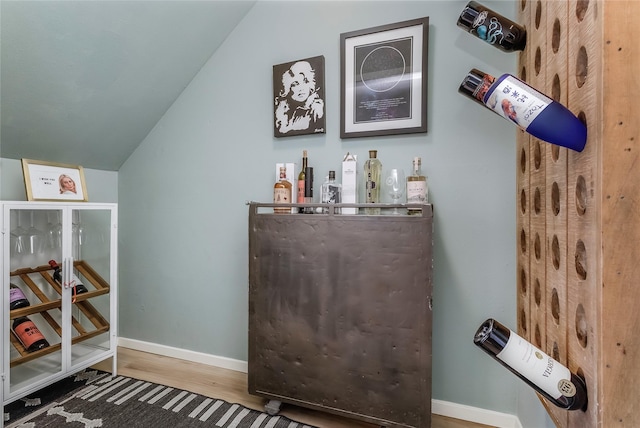 5845 E University Blvd Unit A, Dallas, TX 75206 - bar featuring lofted ceiling, wood finished floors, and baseboards