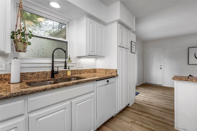 5845 E University Blvd Unit A, Dallas, TX 75206 - kitchen with white dishwasher, a sink, dark stone counters, white cabinetry, and light wood finished floors