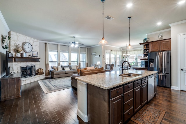 5912 Trail Marker Ct, Fort Worth, TX 76123 - kitchen with a sink, stainless steel appliances, open shelves, ornamental molding, and a fireplace