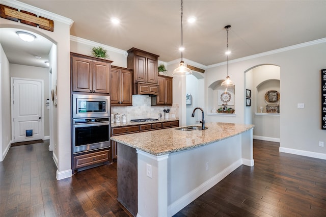 5912 Trail Marker Ct, Fort Worth, TX 76123 - kitchen with appliances with stainless steel finishes, a sink, dark wood-style floors, light stone countertops, and a center island with sink