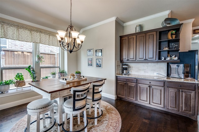 5912 Trail Marker Ct, Fort Worth, TX 76123 - dining space featuring a chandelier, baseboards, dark wood-style flooring, and crown molding