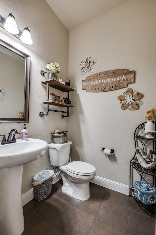 5912 Trail Marker Ct, Fort Worth, TX 76123 - half bath featuring tile patterned flooring, toilet, baseboards, and a sink