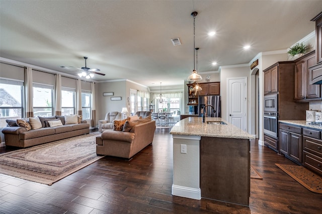 5912 Trail Marker Ct, Fort Worth, TX 76123 - kitchen featuring a sink, stainless steel appliances, ornamental molding, ceiling fan, and light stone counters
