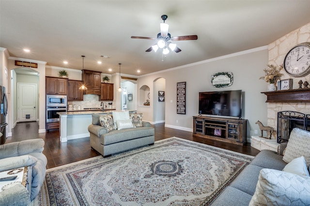 5912 Trail Marker Ct, Fort Worth, TX 76123 - living area with arched walkways, a stone fireplace, dark wood-style floors, ceiling fan, and recessed lighting