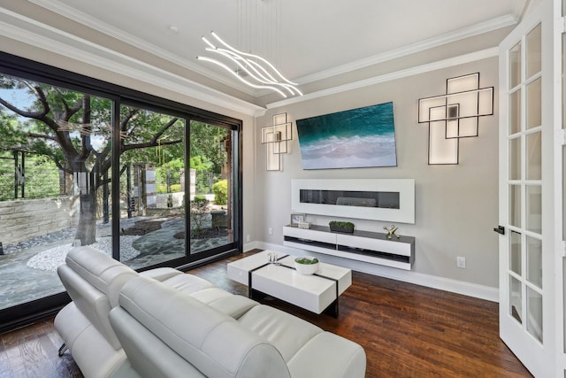 living area with baseboards, wood finished floors, and ornamental molding