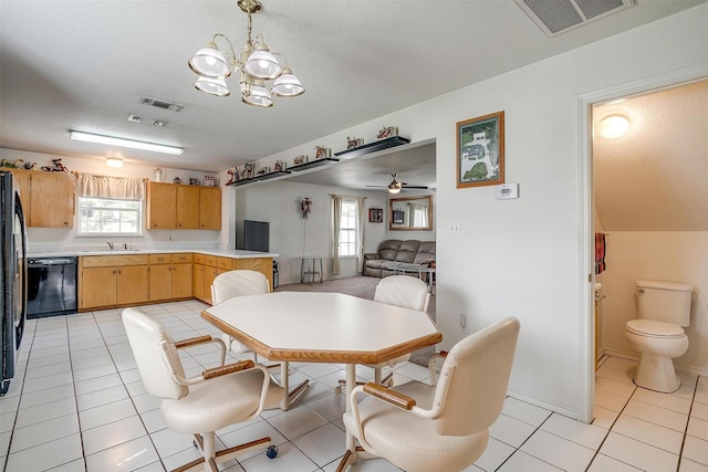 1409 Robyn Rd, Azle, TX 76020 - dining room featuring a textured ceiling, a chandelier, light tile patterned floors, and a ceiling fan