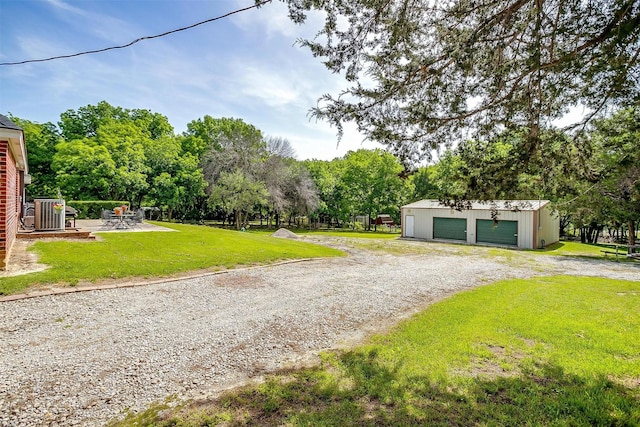 1409 Robyn Rd, Azle, TX 76020 - detached garage with driveway and view of wooded area