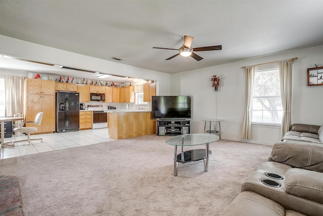 1409 Robyn Rd, Azle, TX 76020 - living room featuring ceiling fan, light colored carpet, and a textured ceiling