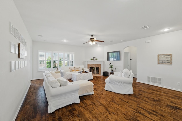 111 Blue Stem Ln, Aledo, TX 76008 - living room with arched walkways, a ceiling fan, dark wood-style floors, baseboards, and a fireplace
