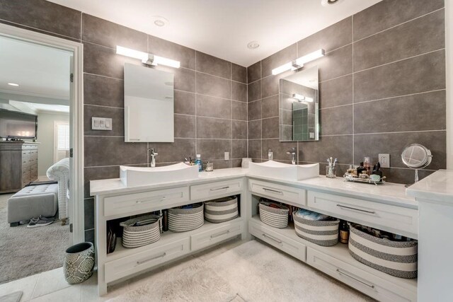 9178 Glen Springs Dr, Dallas, TX 75243 - full bath with tile walls, double vanity, and decorative backsplash
