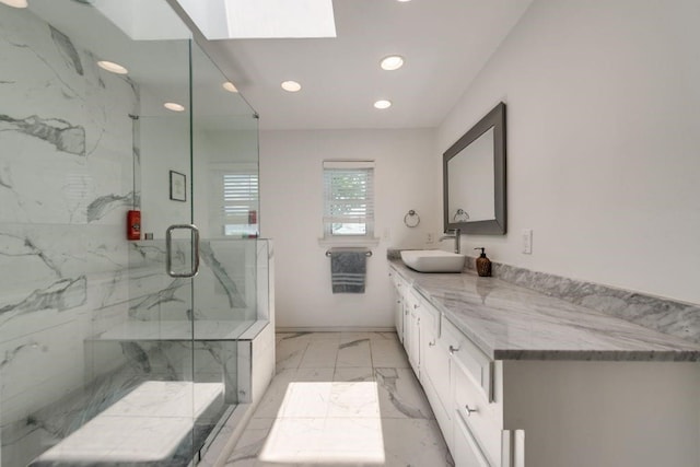 9178 Glen Springs Dr, Dallas, TX 75243 - full bath featuring marble look tiles, recessed lighting, a marble finish shower, vanity, and a skylight