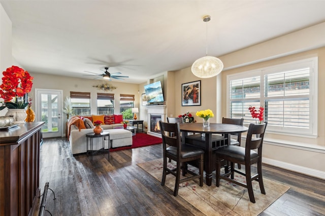 619 Comal Dr, Crandall, TX 75114 - dining space with healthy amount of natural light, dark wood finished floors, and a glass covered fireplace
