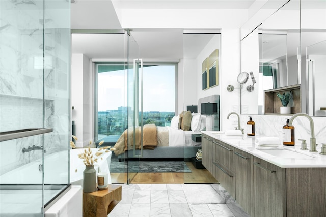 3130 N Harwood St Unit 903, Dallas, TX 75201 - ensuite bathroom featuring marble finish floors, double vanity, an enclosed shower, and tasteful backsplash