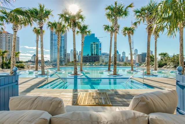 3130 N Harwood St Unit 903, Dallas, TX 75201 - view of swimming pool featuring a skyline view and a hot tub